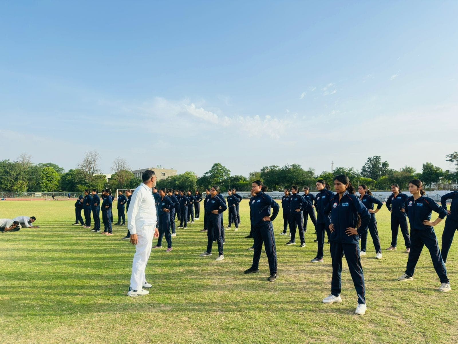 Women recruits in navy tracksuits line up for a warm-up drill at a Project Virangana training camp, Shakti Udghosh Foundation.
