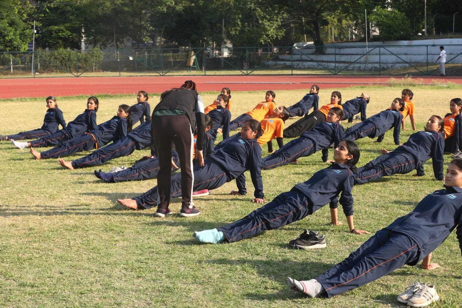 Women recruits perform a backward stretch during guided yoga at a Project Virangana training camp, Shakti Udghosh Foundation.