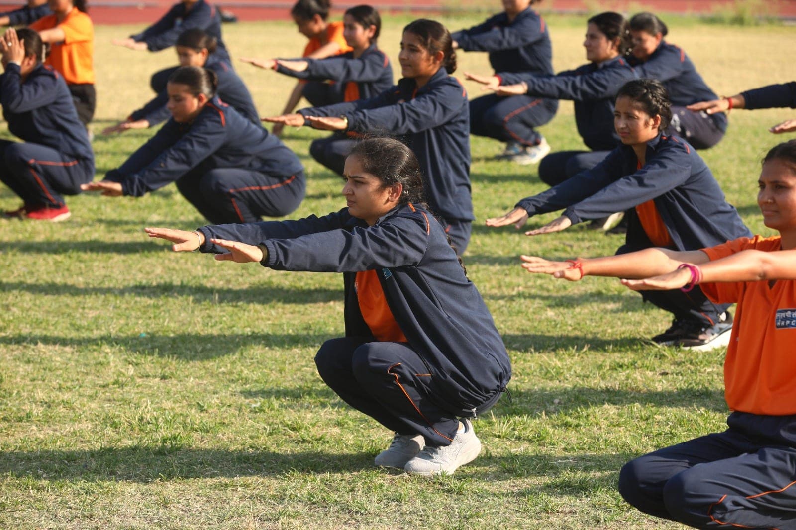 Women recruits hold a squat during strength drills at a Project Virangana training camp, Shakti Udghosh Foundation.
