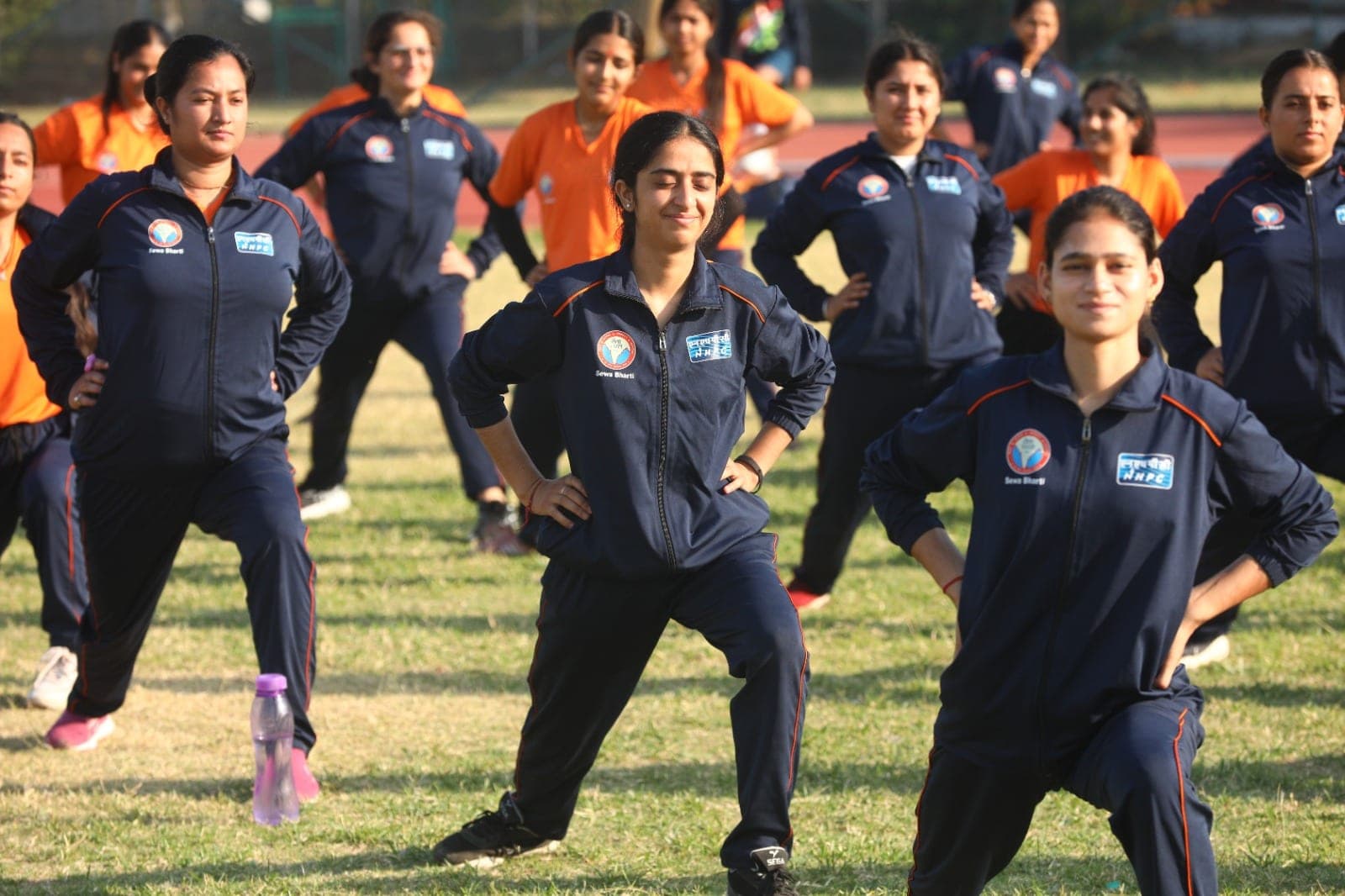 Smiling women recruits perform lunges during a fitness session at a Project Virangana training camp, Shakti Udghosh Foundation.