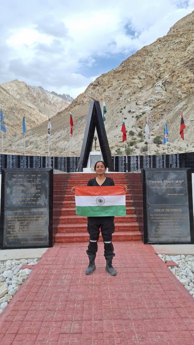A Shakti Udghosh rider at a Himalayan war memorial with the national flag
